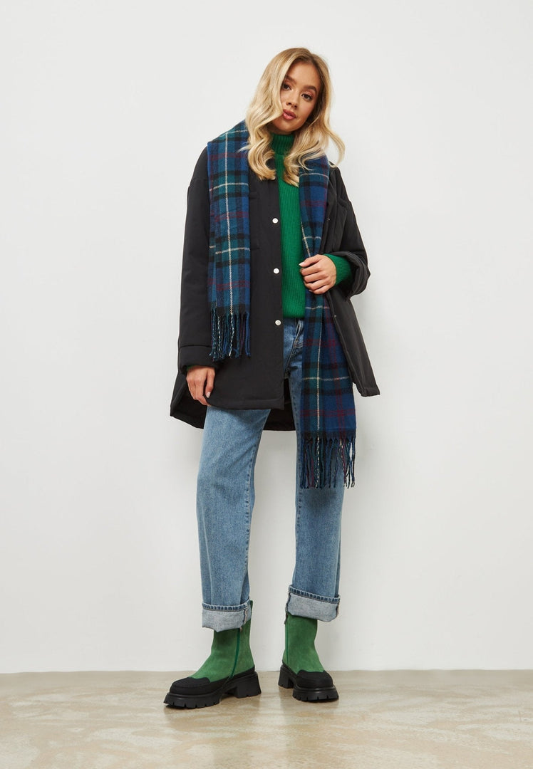 A pair of stylish green urban platform ankle boots for women, making a fashionable statement in footwear.