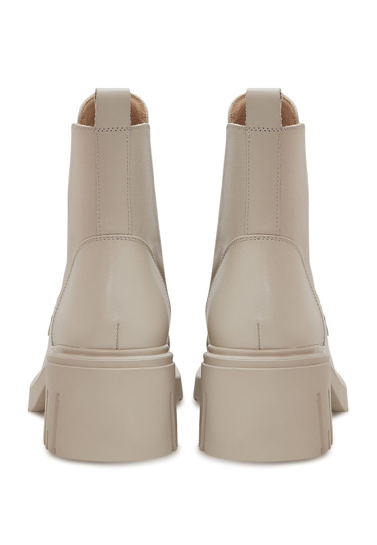 A stylish pair of beige ankle boots for women with chunky heels, featuring trendy chain details for a fashionable look.