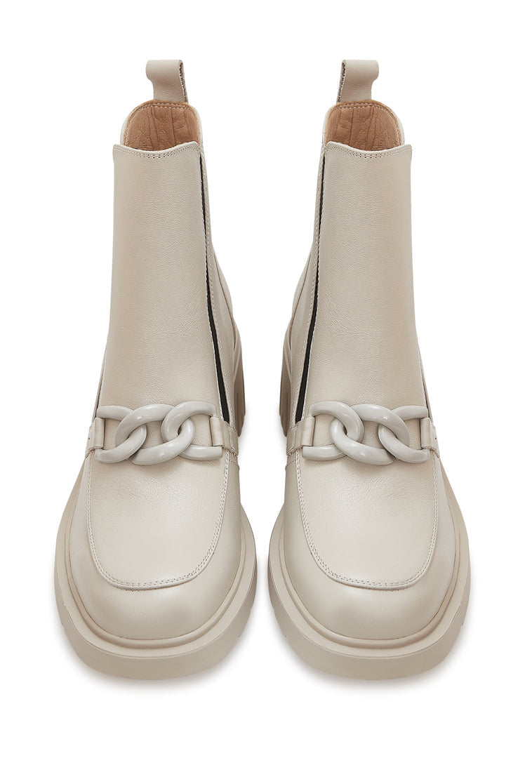 A stylish pair of beige chunky heel ankle boots with chain detail, perfect for women looking for fashionable heel boots.