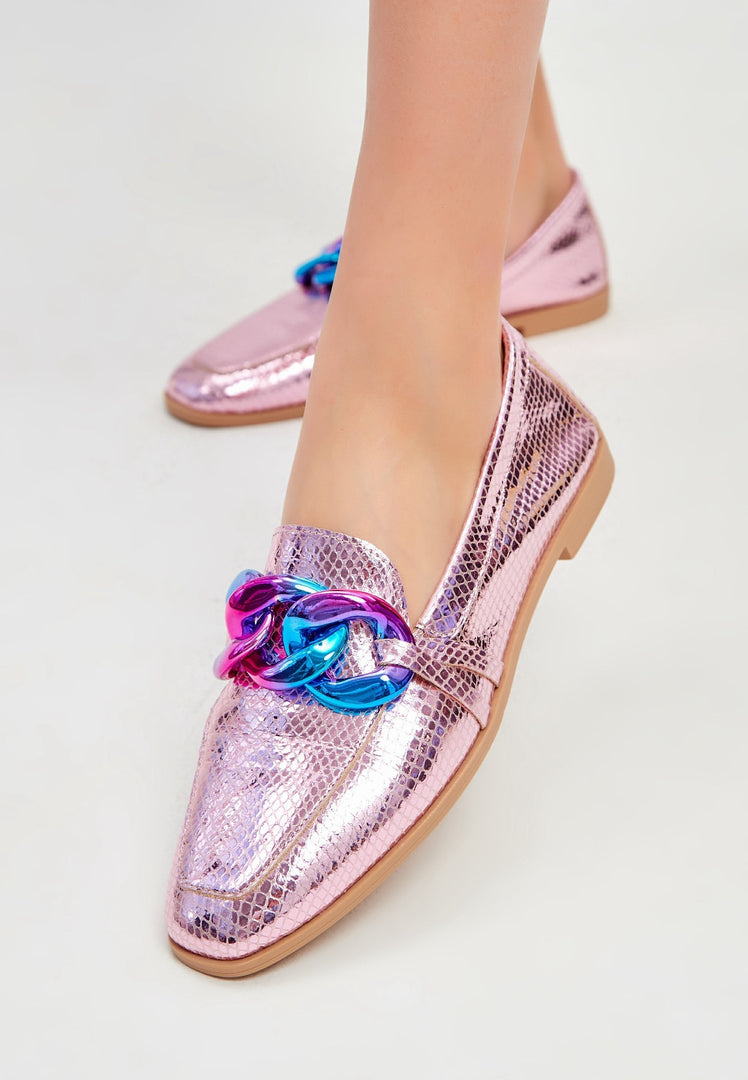 A trendy pair of leather loafers with a flat metallic pink sole, perfect for classic style women's fashion.