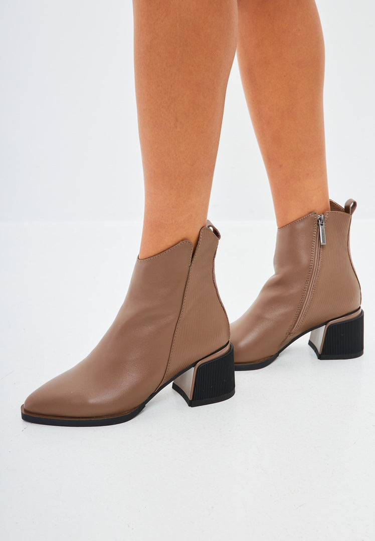 A pair of stylish brown leather women's ankle boots, perfect for a casual and trendy look.