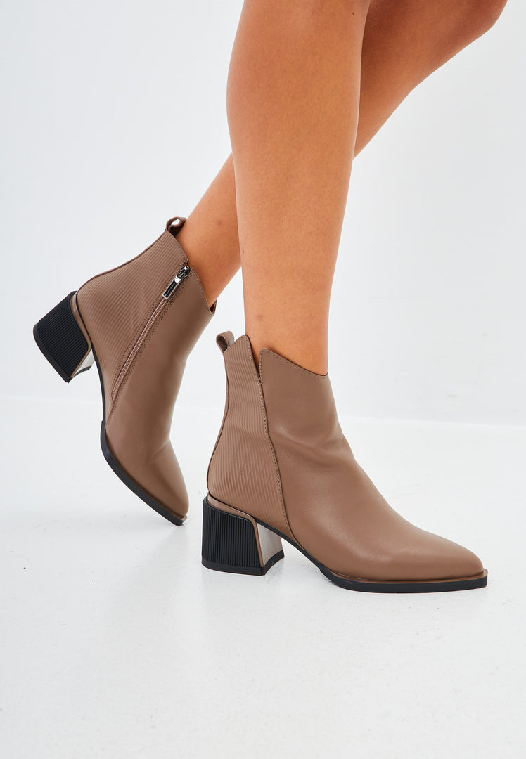 A pair of stylish brown leather ankle boots for women, perfect for a casual look.