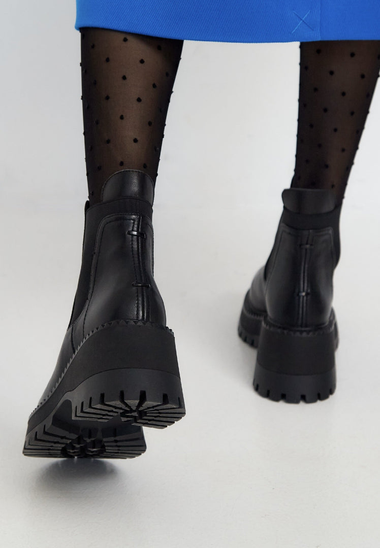 A stylish pair of black platform Chelsea boots for women, featuring a chunky design perfect for trendsetters.