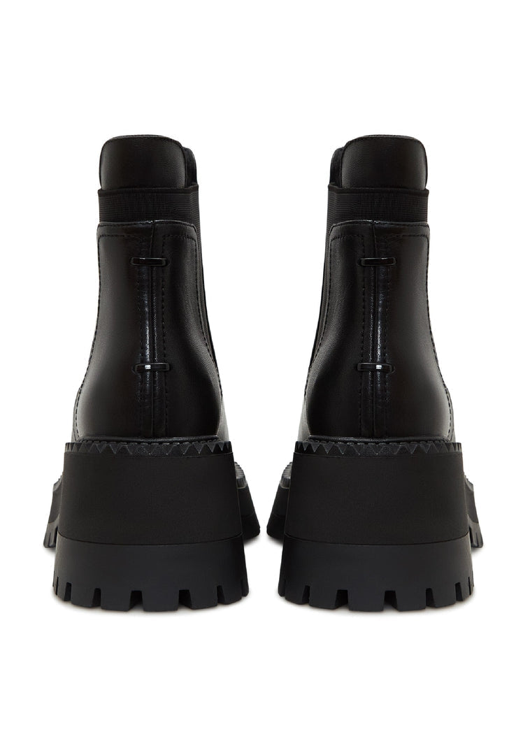 A pair of stylish black platform Chelsea boots for women, featuring a chunky silhouette perfect for a trendy and edgy look.