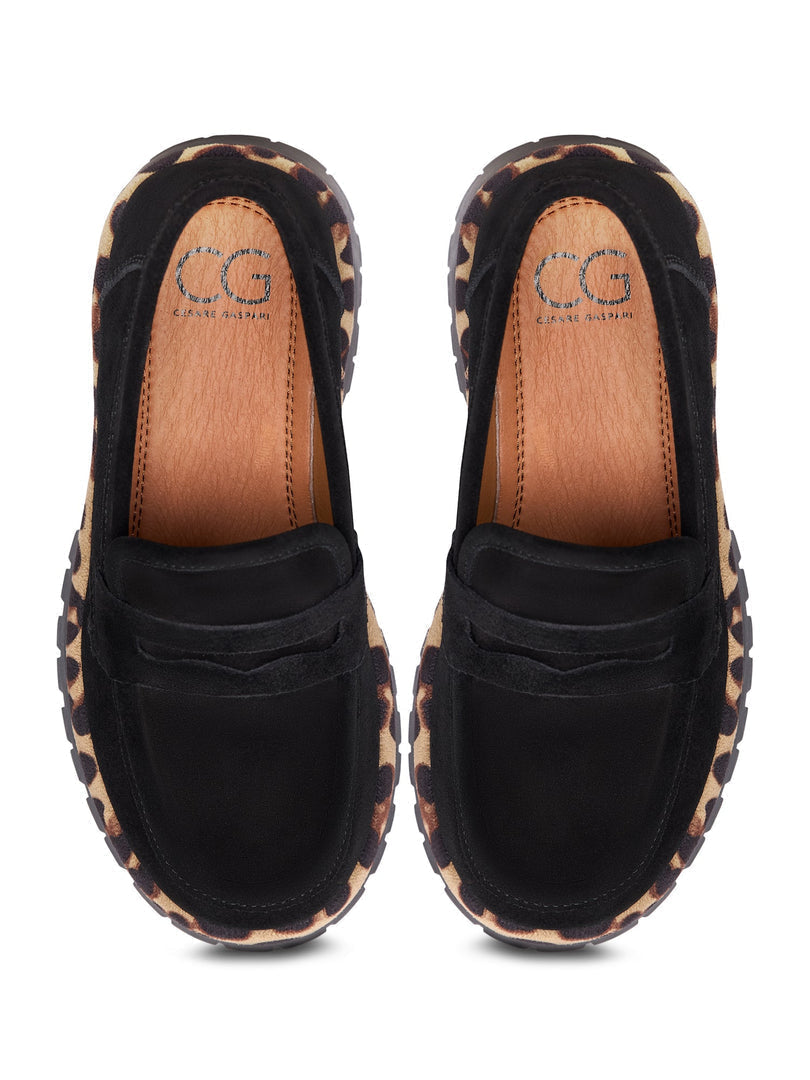 A trendy pair of Lily black loafers with a chunky sole, perfect for adding a chic and fashionable touch to any outfit.