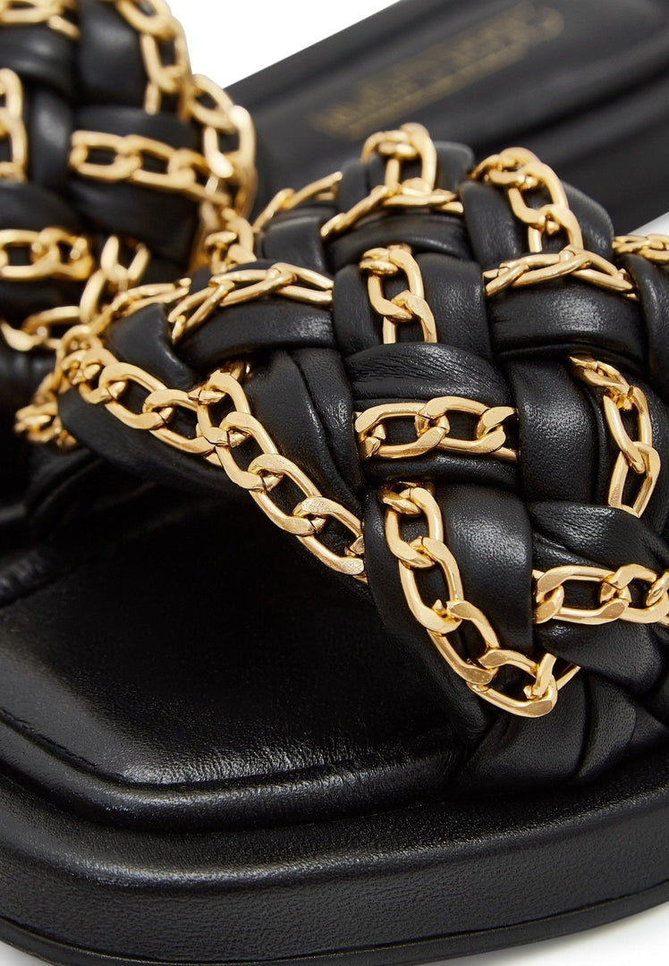 A stylish pair of black leather chain sandals for women, perfect for summer outings with intricate chain detailing.