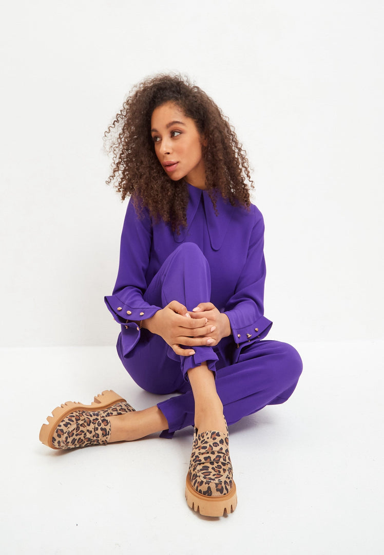 A stylish pair of chunky platform loafers in leopard print, perfect for women looking to make a statement with their footwear.