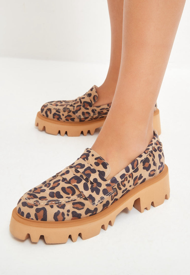 A trendy pair of chunky platform loafers in a striking leopard print, perfect for fashion-forward women looking to make a statement with their footwear.