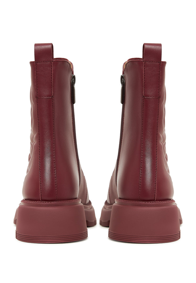 A pair of fashionable Bordeaux leather platform ankle boots for women, featuring a high heel design.