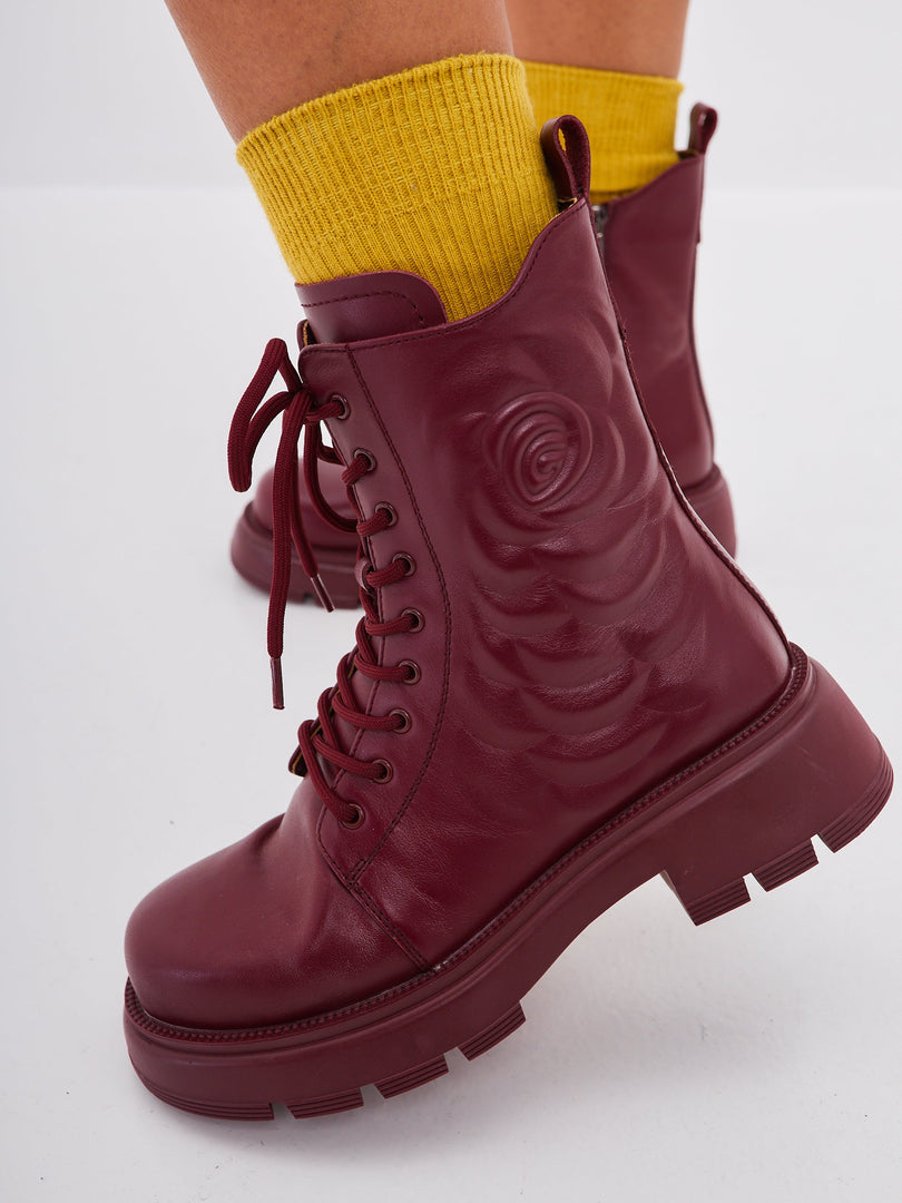 A stylish pair of women's leather platform ankle boots in a trendy bordeaux color, featuring high heels - perfect for fashion-forward individuals looking for fashionable ankle footwear.