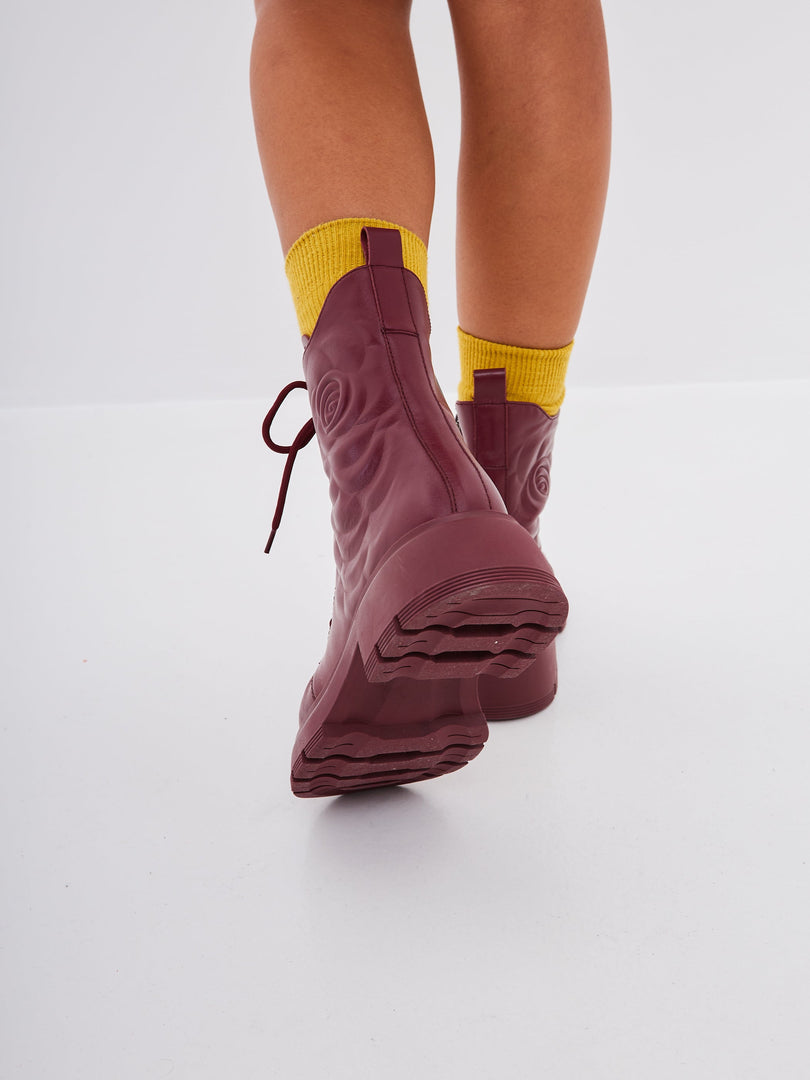 A stylish pair of women's leather platform ankle boots in Bordeaux color, featuring high heels, perfect for a fashionable footwear look.