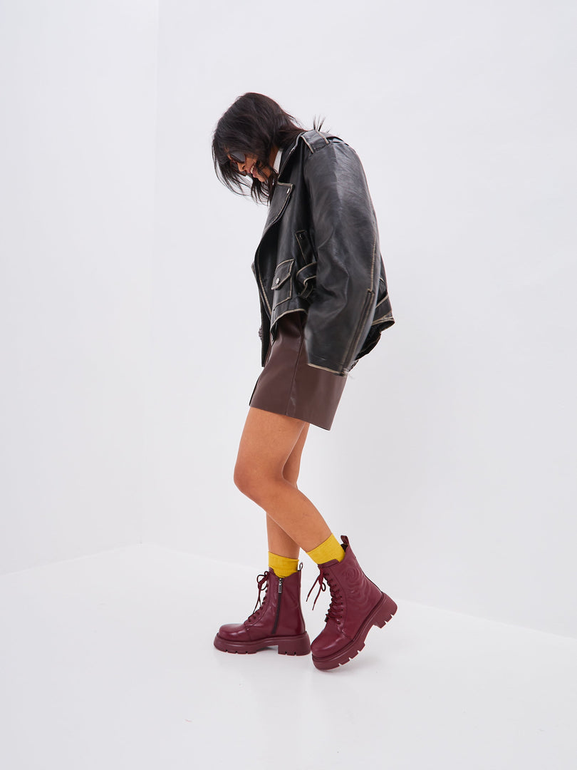 A stylish pair of Bordeaux leather platform ankle boots for women, featuring high heels and a fashionable design.