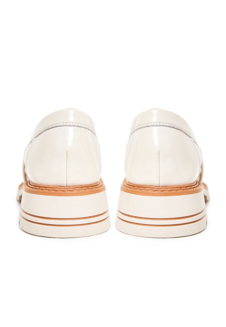 A stylish pair of women's block heels loafers in beige, fashionable and comfortable for all-day wear.