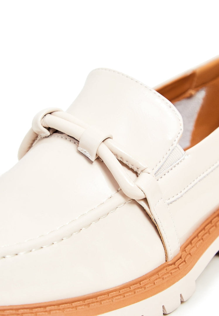 A stylish pair of beige block heels loafers for women - fashionable and comfortable footwear option.