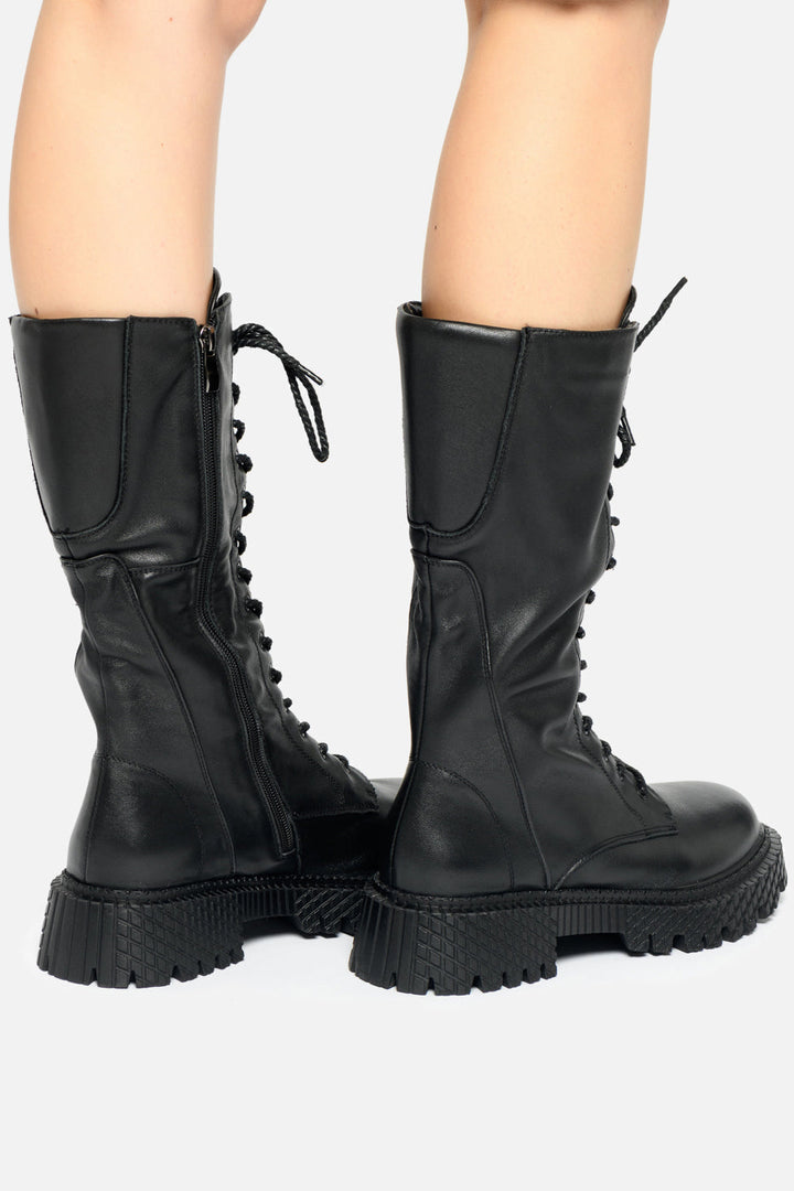 A pair of black high-laced combat boots, perfect for any military enthusiast or anyone seeking stylish and durable tactical lace-up footwear.