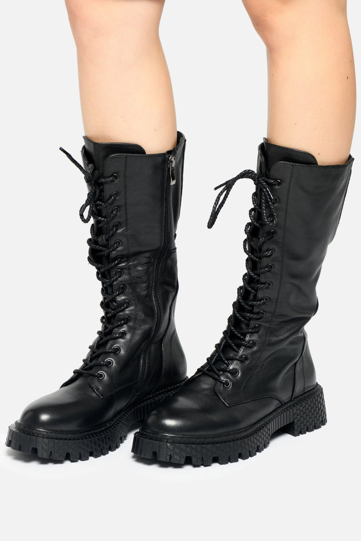 A pair of rugged high-top battle boots, perfect for military or tactical use, featuring a high-laced design for added support and durability.