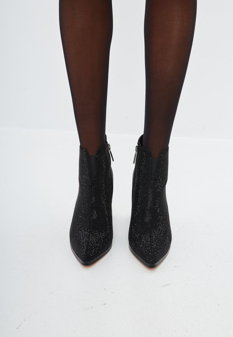 A fashionable pair of stylish black suede pointed toe ankle boots with a block heel, perfect for any outfit.