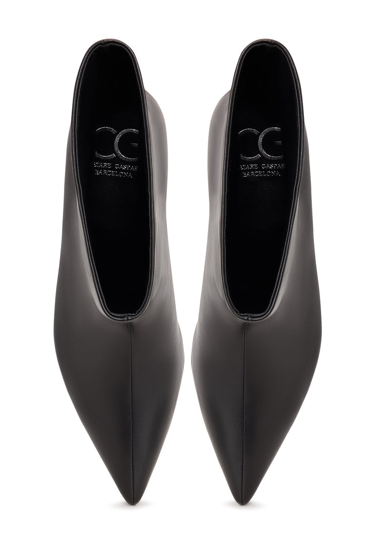 A trendy pair of black ankle boots with kitten heels, known as Regina boots, perfect for women's outfits.