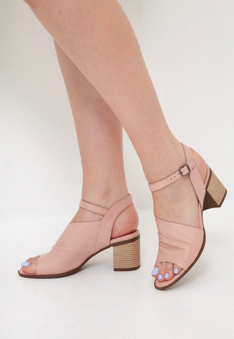 A stylish pair of women's pink leather block heel sandals, featuring a chunky heel design for a trendy and comfortable look.
