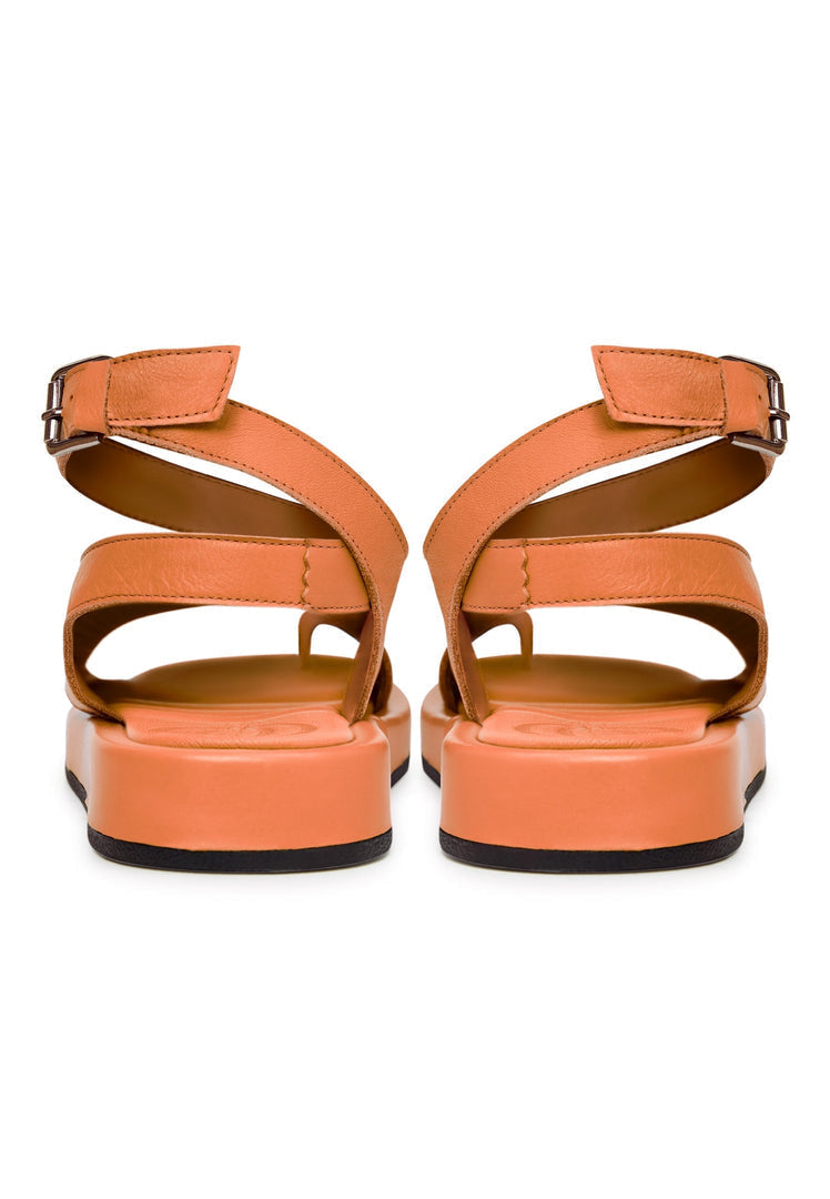 A close-up shot of stylish orange leather platform sandals, perfect for adding a pop of color to any outfit.