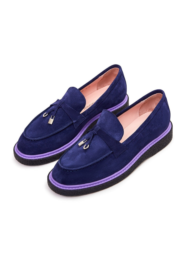 A pair of stylish navy blue suede slip-on loafers for men.