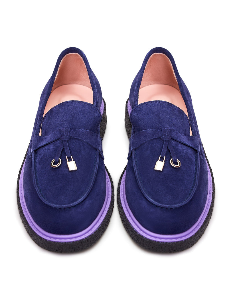 A stylish pair of men's navy blue suede slip-on loafers.