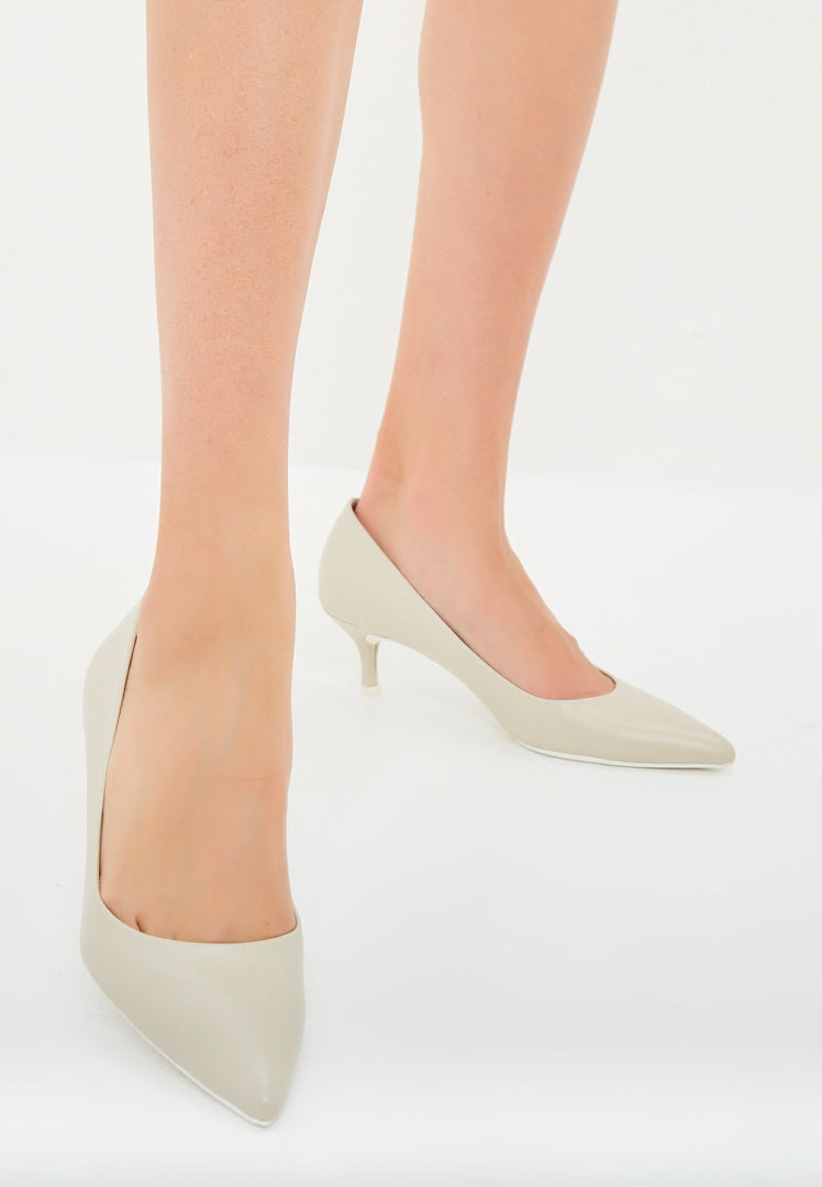 A pair of elegant luxe off white pumps, perfect as luxe heels or designer pumps for a white wedding ensemble.