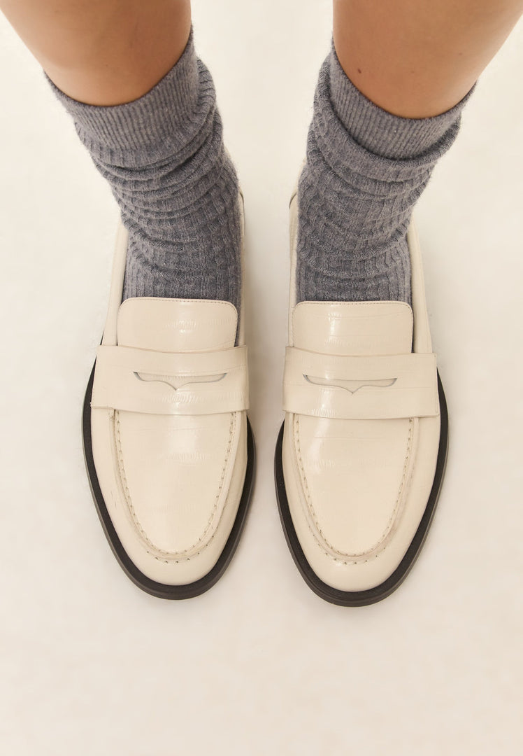 A stylish pair of white leather block heeled loafers for women, the perfect fashionable addition to any outfit.