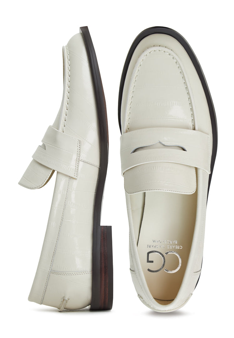 A stylish pair of women's white leather block heeled loafers, perfect for a fashionable and comfortable look.