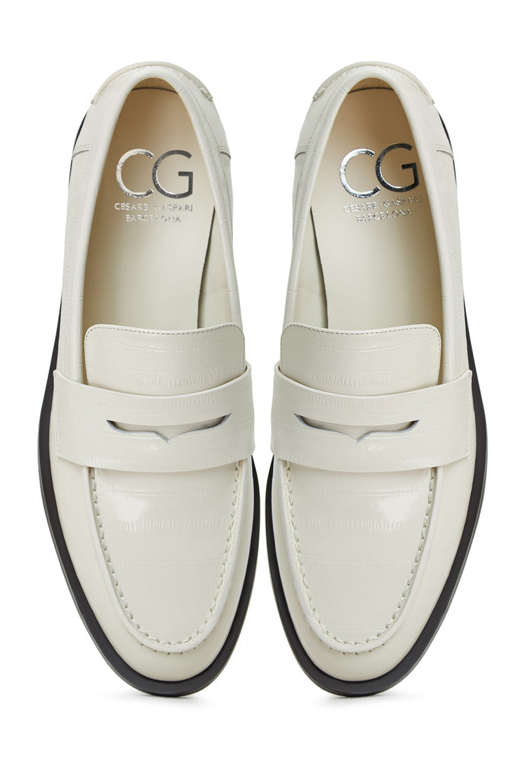 A stylish pair of white leather block heeled loafers, perfect for women looking for fashionable and comfortable leather slip-on shoes.
