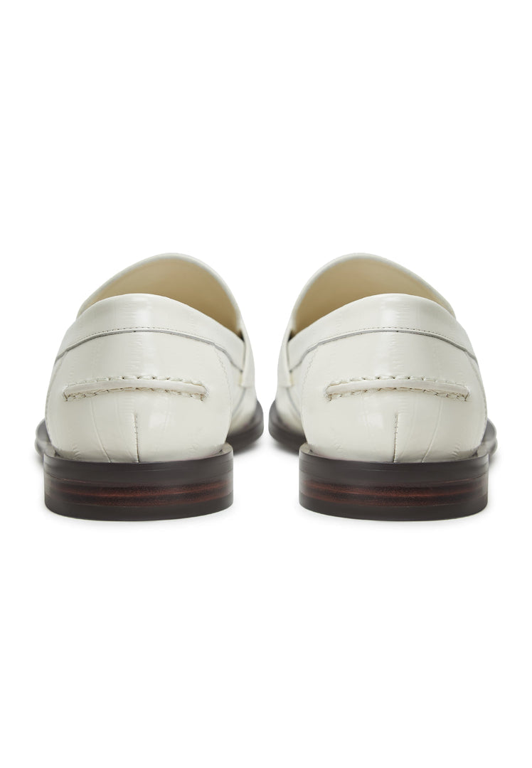A stylish pair of women's white leather block heeled loafers, perfect for a fashionable and comfortable look.