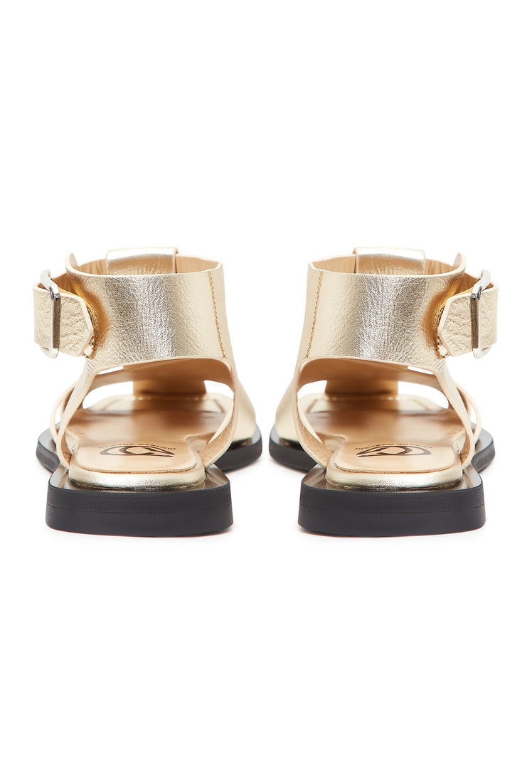 A pair of stylish gold ankle cuff flat sole sandals for women, perfect for summer footwear.