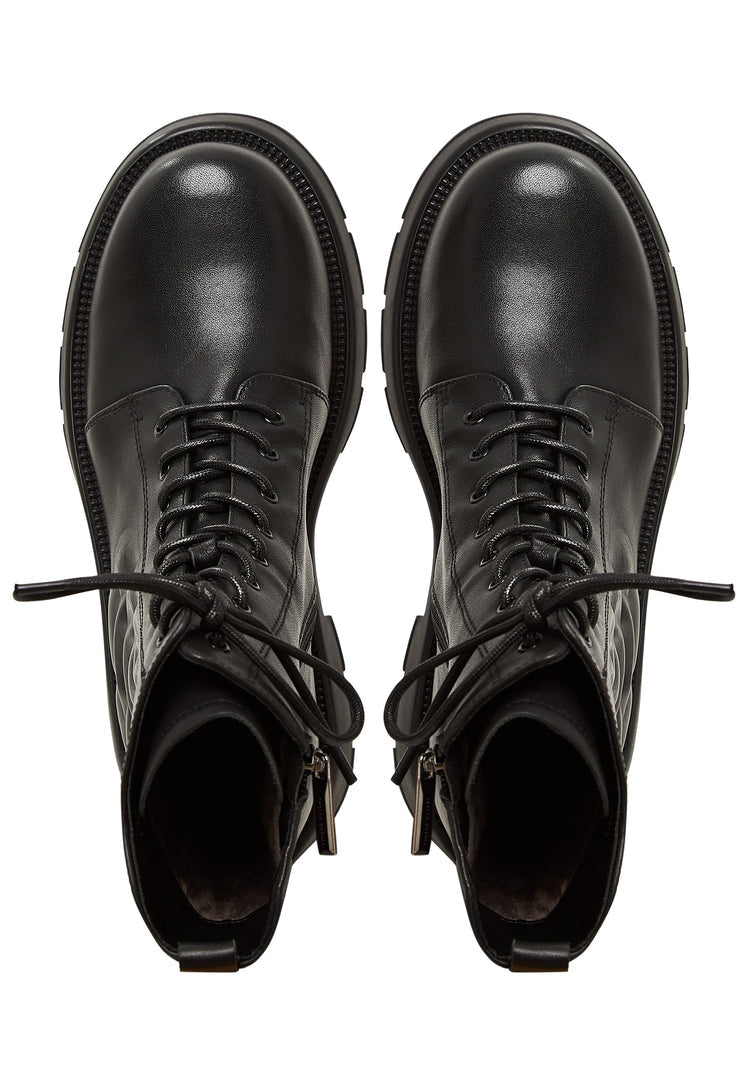 A pair of fashionable women's black leather platform ankle boots with high heels.