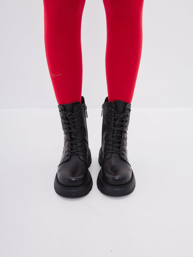 A fashionable pair of women's high heel black leather platform ankle boots.