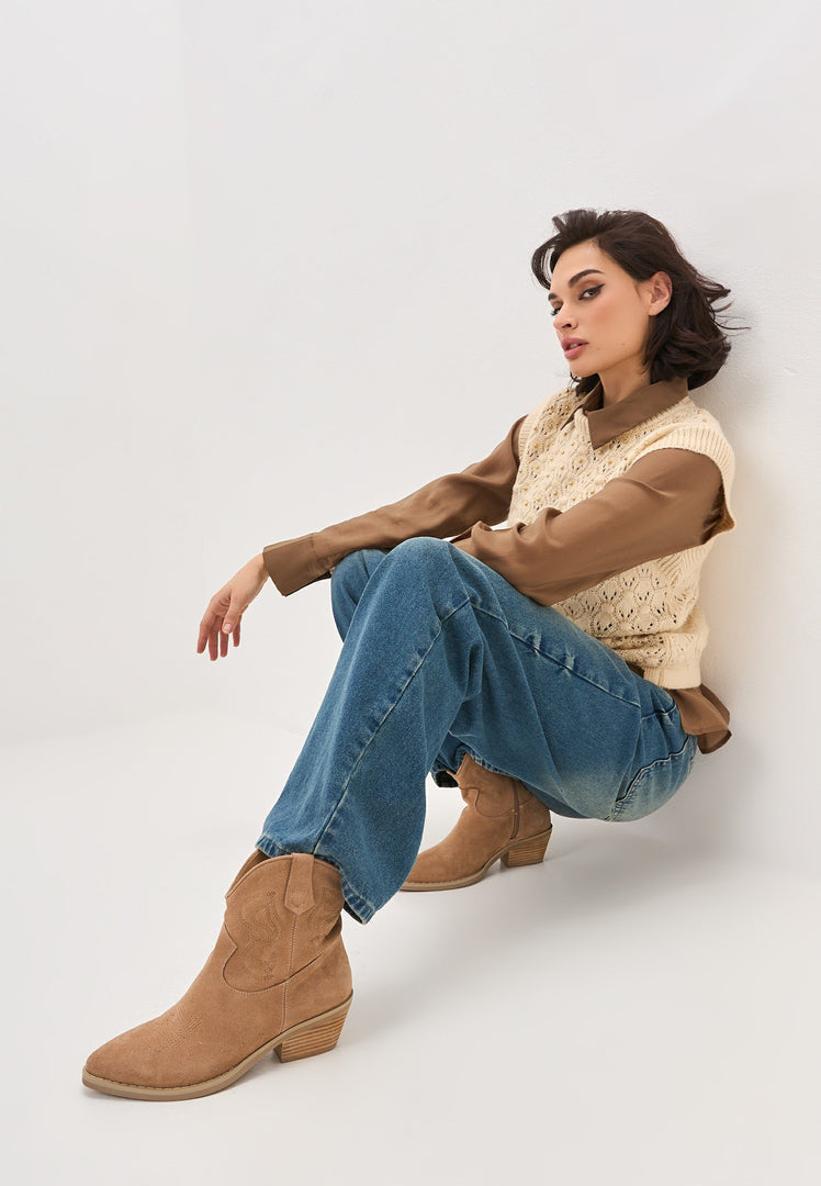 A pair of stylish Natalie brown suede cowboy boots, perfect for adding a touch of Western style to your cowgirl fashion look.