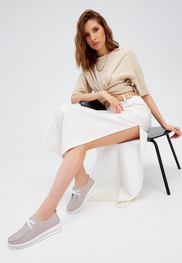 A stylish pair of beige leather platform loafers for women, combining the classic design of leather loafers with the comfort of a platform sole.