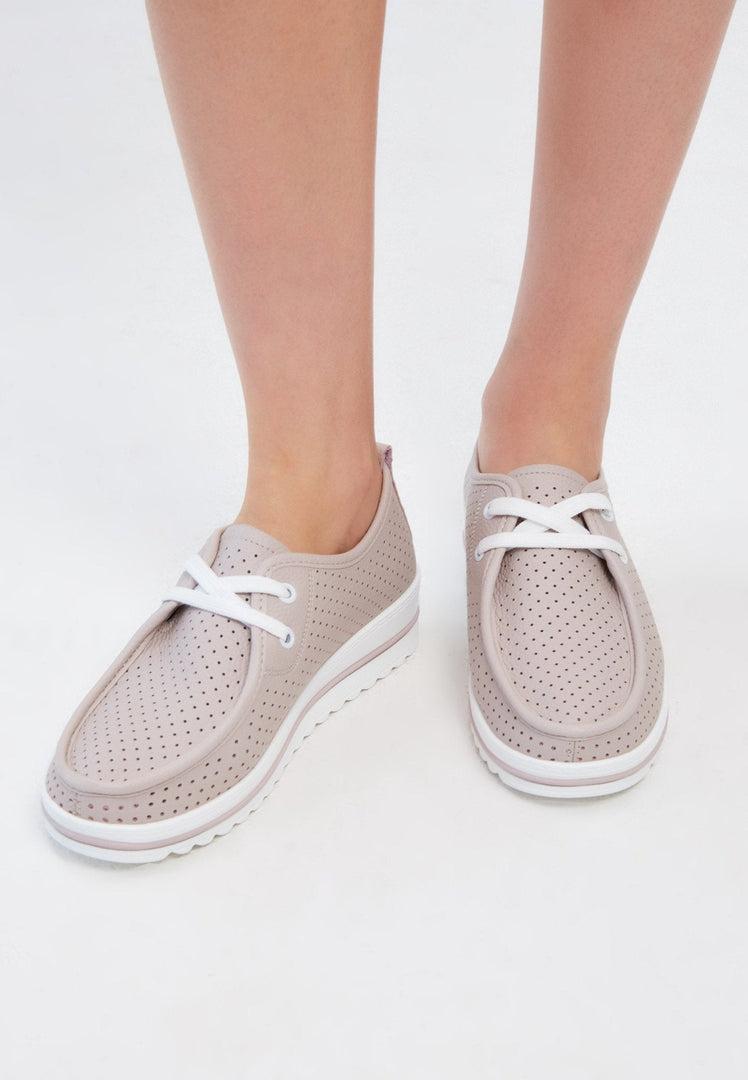 A stylish pair of beige leather platform loafers, perfect for women looking for comfortable and classic footwear.