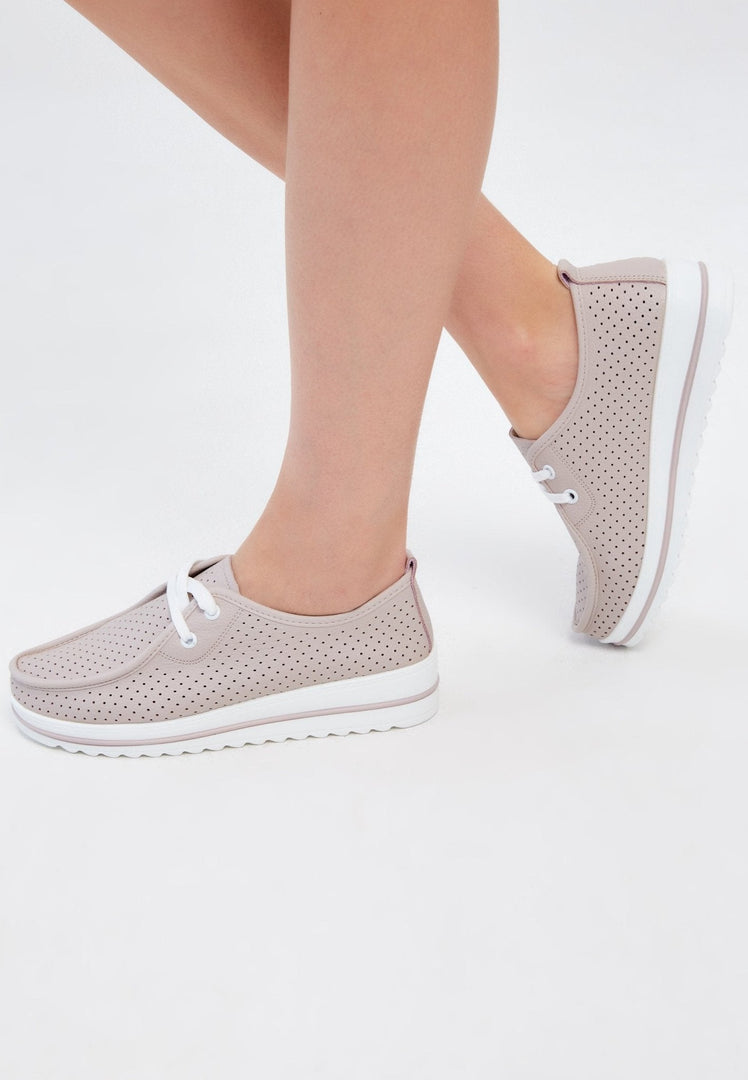 A pair of stylish beige leather platform loafers for women, classic and comfortable.