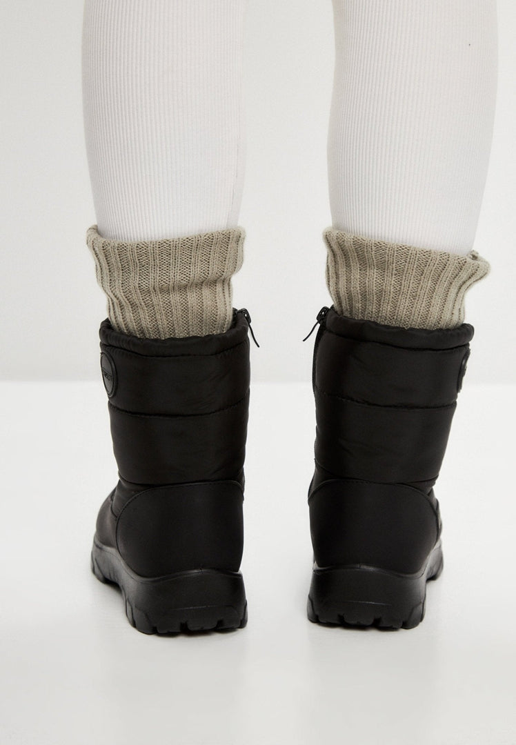 Stay warm and cozy this winter with waterproof insulated snow boots featuring fur lining and snow grips.