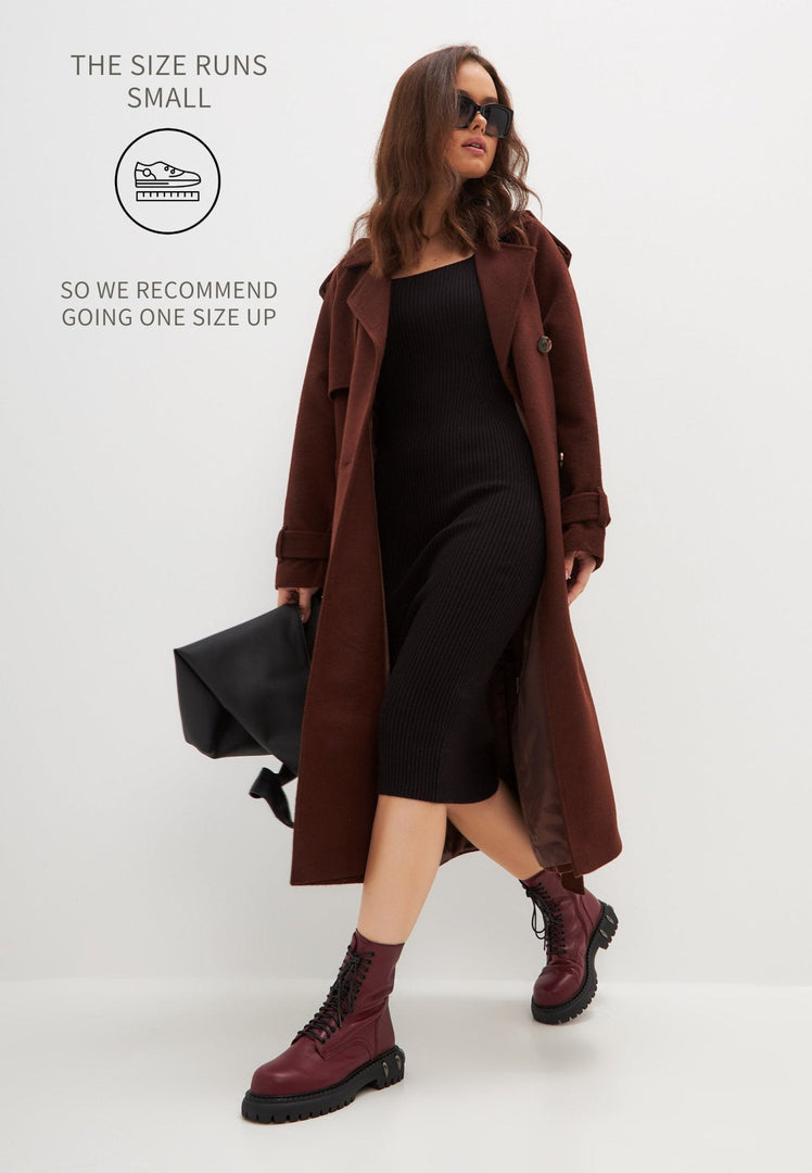 A pair of stylish lace-up combat boots with a chunky sole in a rich Bordeaux color, perfect for women's fashion footwear.