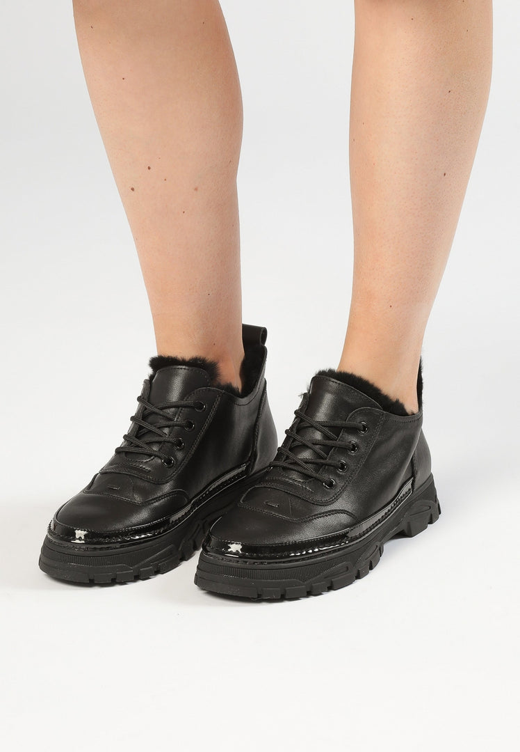 A pair of stylish black chunky sneakers made with luxurious merino wool lining for ultimate comfort and durability.