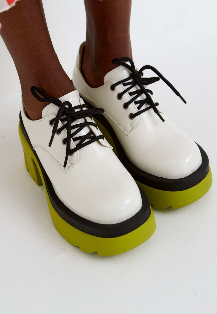 A stylish pair of women's fashion oxfords in white featuring bold chunky block heels and lace-up detail.