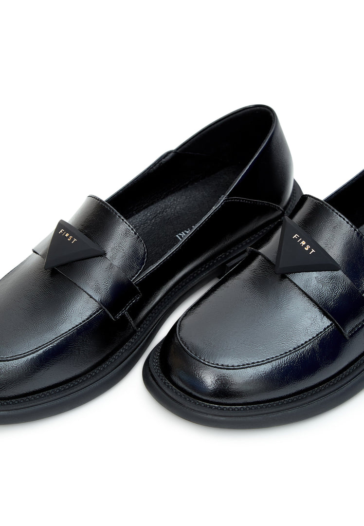 A pair of stylish black slip-on loafers, perfect for any occasion, ideal for men looking for classic and comfortable slip-on shoes.