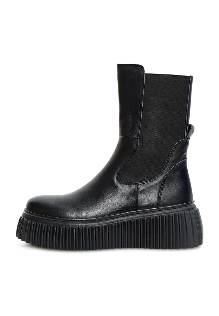 A trendy pair of black Chelsea boots with a ribbed sole and platform design, perfect for women's footwear fashion.