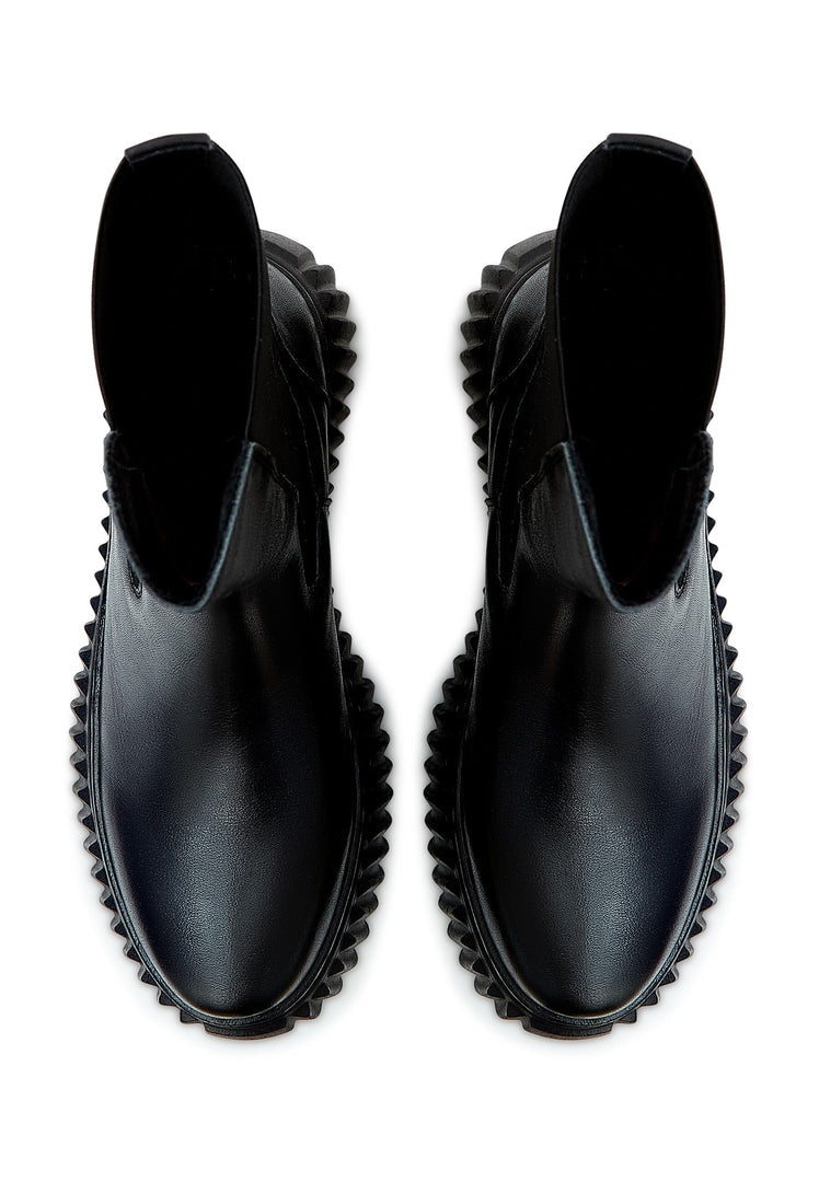 A fashionable pair of black Chelsea platform boots with ribbed soles, perfect for women's footwear collections.