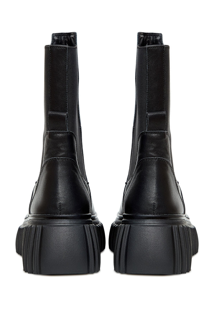 A stylish pair of women's black Chelsea boots with a trendy ribbed sole, perfect for a comfortable and fashionable look.