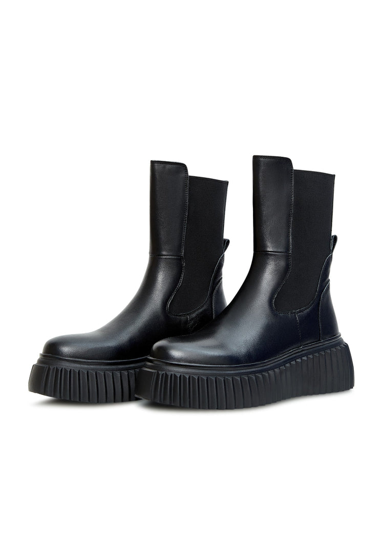 A stylish pair of women's Chelsea boots with a ribbed sole in black, featuring a platform design for a fashionable look.