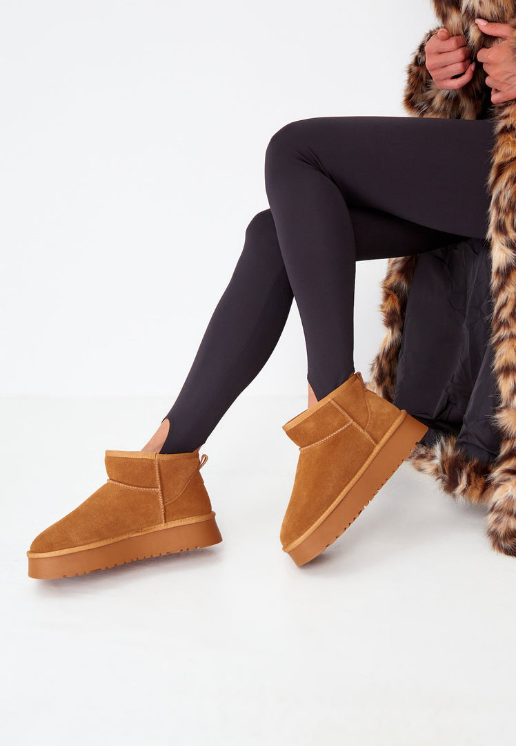 A stylish pair of brown suede platform winter boots, perfect for adding a trendy touch to your winter fashion wardrobe.