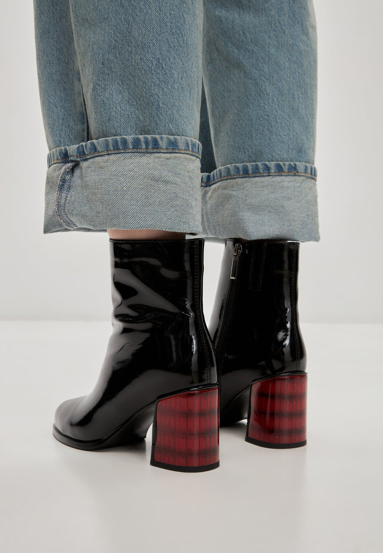 A stylish pair of women's soft leather Ella heel boots in patent black, perfect for any outfit.