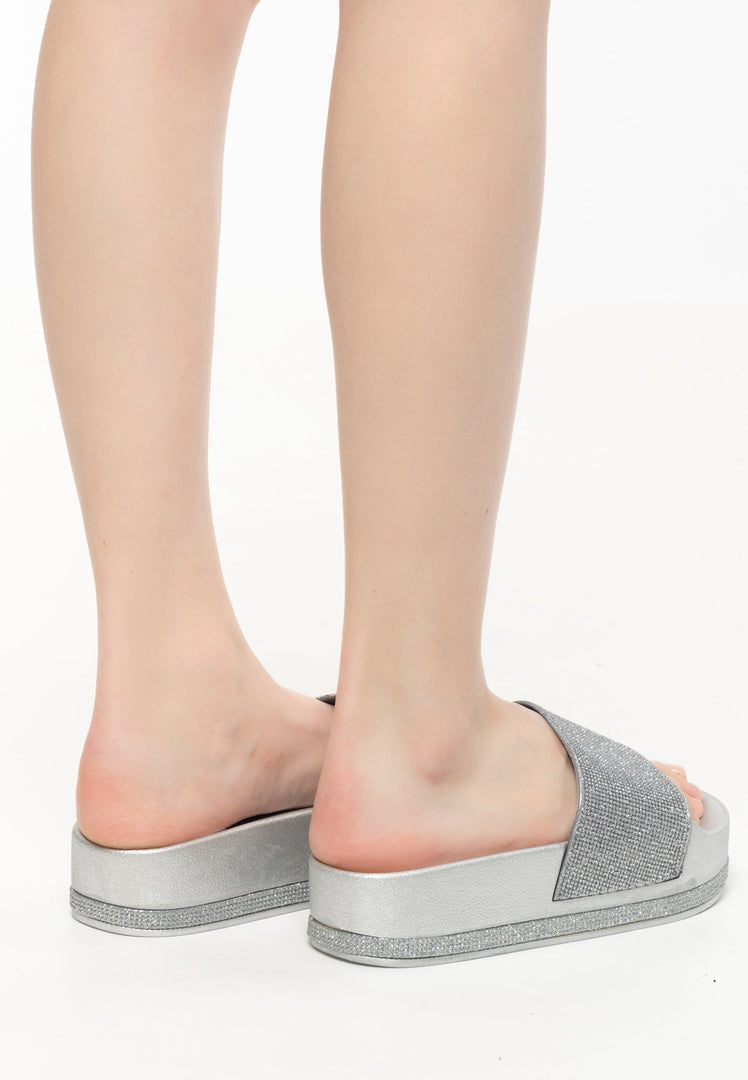 A trendy pair of silver platform flip flops for women, perfect for a fashionable summer look.
